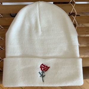 White beanie with rose embroidery. Very warm and haven’t been used.